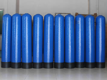 Ten blue FRP tanks with standard base is on the ground in a row.
